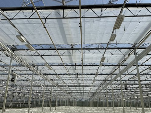 greenhouse with half closed screens on a sunny day